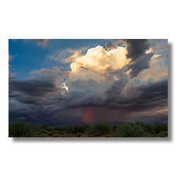 A magnificent white thunderhead cloud dominates the sky above Congress, AZ, signaling the power and beauty of the monsoon season.