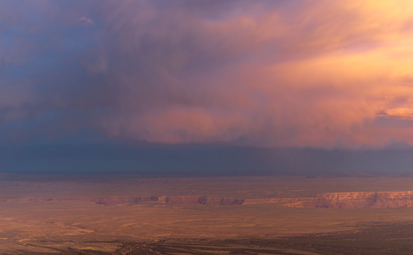 A summer monsoon storm rolls over Marble Canyon at sunset.