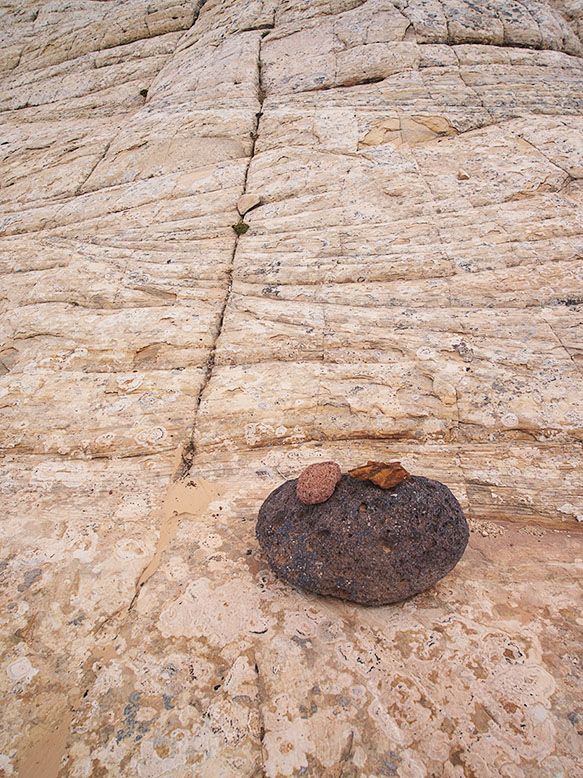 Photo of detrail rocks collecting at the foot of a petrified sand dune along the Burr Trail. 
                Photo by Jim Witkowski