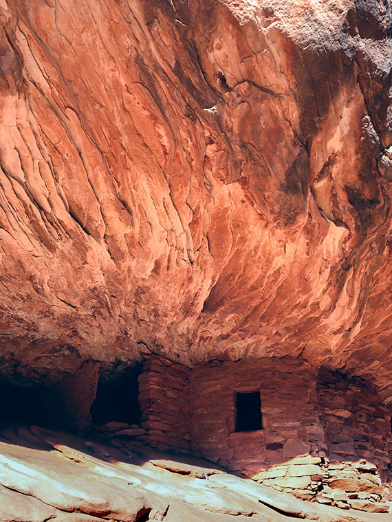 Pueblo ruins in a cave on Cedar Mesa where the roof has the texture and colour of flames.