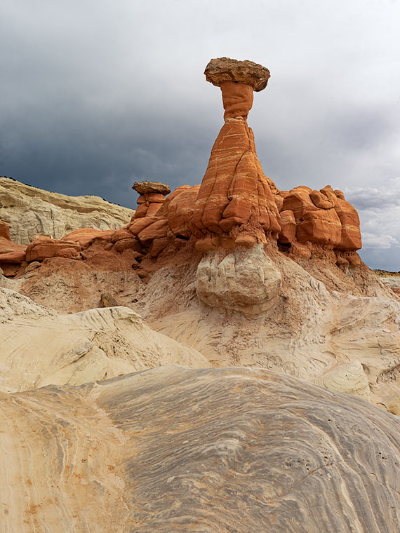 A capstone sits atop a column of red sandstone near Kanab, Utah.