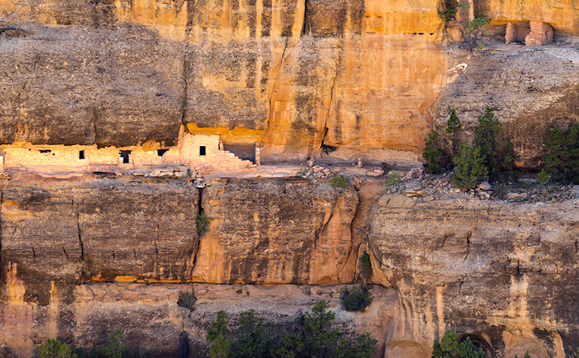 Mesa Verde cliff wall with ancient Black Ruins built into the rock, showcasing darkened varnished walls.