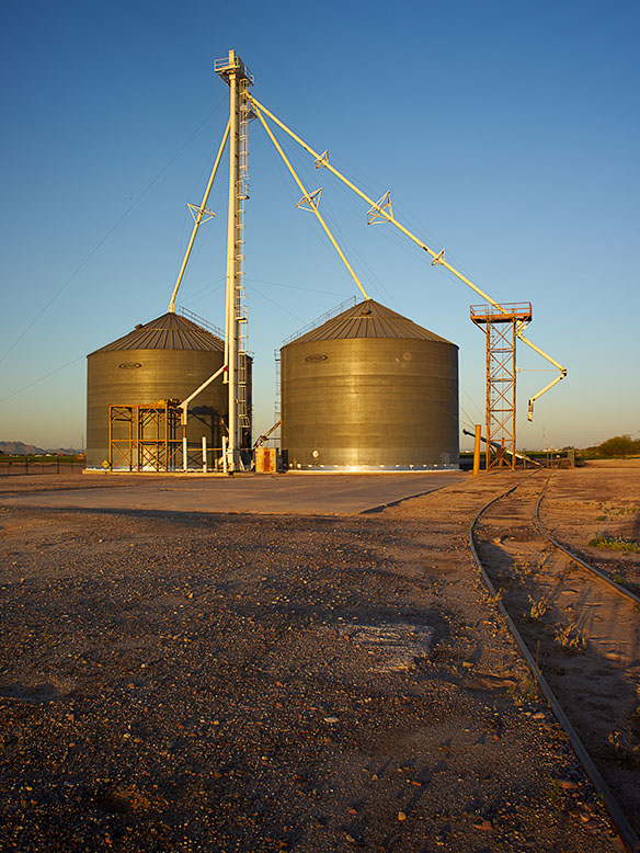 The grain silos in the photograph are located in Buckeye, Arizona. 
                Jim Witkowski shot this image during a rising sun.