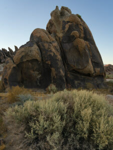 Alabama Hills rock formation before dawn with a tumbleweed in the foreground