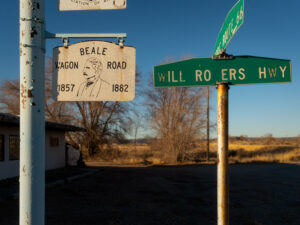 Beale Wagon Road sign with Route 66 and Will Rogers Highway street signs in a rural Arizona setting