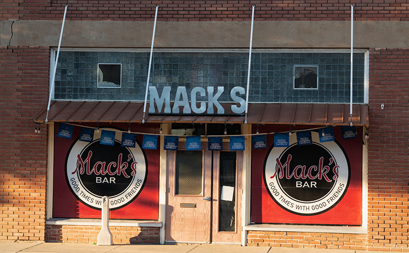 A sight that its patrons may never see is the early morning light on the front of Mack's Bar.