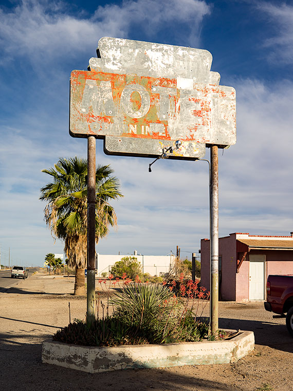 A faded motel sign marks this motel's location on US Highway 60 in Aguila Arizona