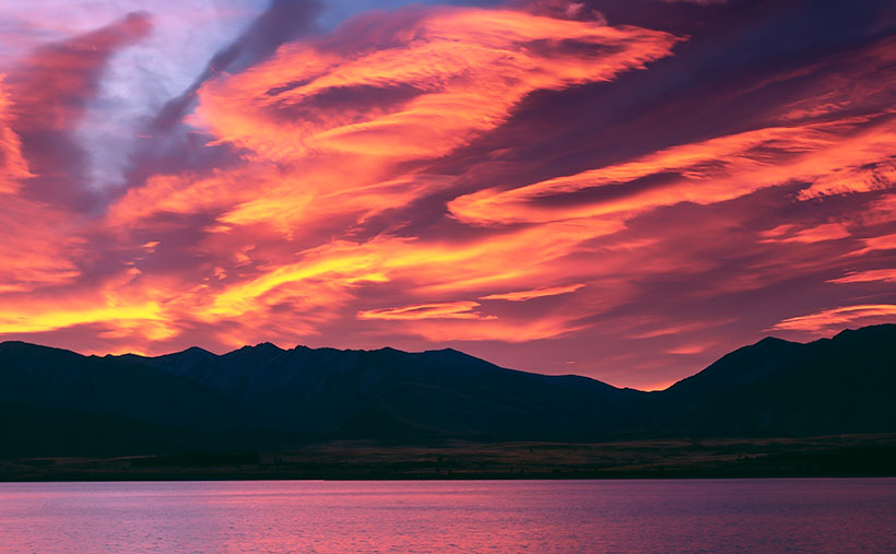 A colorful sunrise over the Two Thumb Range at Lake Tekapo, New Zealand.