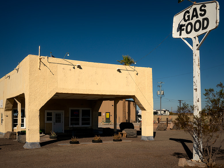 1940s vintage gas station in Agua Caliente, now operating as an ice cream shop under a clear blue sky.