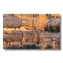 Mesa Verde cliff wall with ancient Black Ruins built into the rock, showcasing darkened varnished walls.