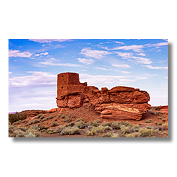 The Wukoki pueblo ruins rising starkly from the arid landscape at Wupatki National Monument under a painted sky.