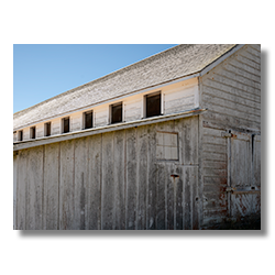 Close-up of weathered upper windows on a rustic building at Pierce Point Ranch, Point Reyes, California