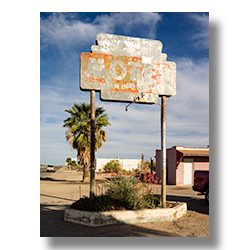 A faded sign marks the locaction of this motel in Aguila Ariozona.