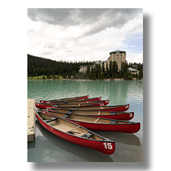 Red rental canoes on a rainy day at Lake Louise.