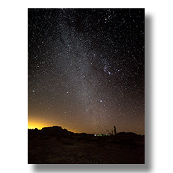 Silhouette of KofA Mountains against Phoenix lights, with the Milky Way and Orion constellation rising in the night sky.