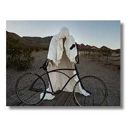 White ghostly sculpture with bicycle, The Ghost Rider by Albert Szukalski, at Goldwell Open Air Museum.