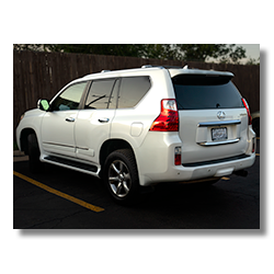 White family SUV parked in motel lot, captured during travel stop