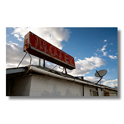 Abandoned motel sign atop a closed motel in Gallup, New Mexico