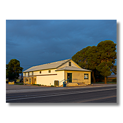 The rising sun lighs the Palo Verde Post Office under a monsoon storm on the west side of Phoenix